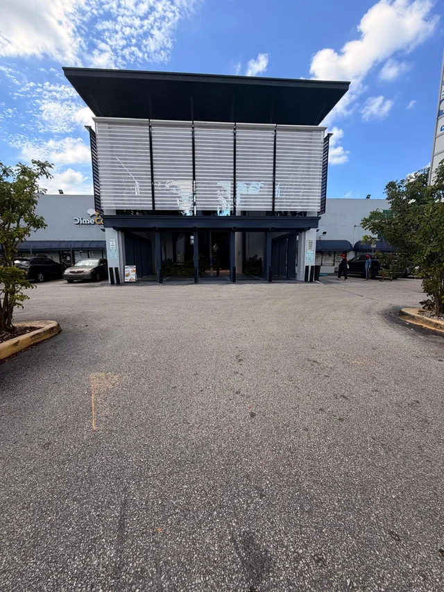 Entrance below the silver metal panels